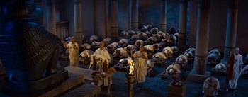 Movie still from “The Egyptian” (1954), directed by Michael Curtiz – A group of people sitting around a fire; Extreme Wide shot, High angle