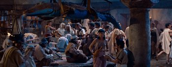 Movie still from “The Egyptian” (1954), directed by Michael Curtiz – A group of people dressed in ancient egyptian clothing; Wide shot, High angle