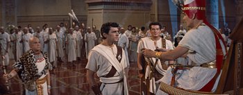 Movie still from “The Egyptian” (1954), directed by Michael Curtiz – A group of men dressed in ancient roman garb; Medium shot, High angle