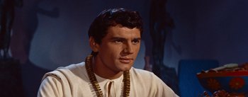 Movie still from “The Egyptian” (1954), directed by Michael Curtiz – A person wearing a white shirt; Close Up shot, Low angle