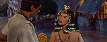 Movie still from “The Egyptian” (1954), directed by Michael Curtiz – A woman in a costume talking to a man in a costume; Close Up shot, Over the shoulder angle