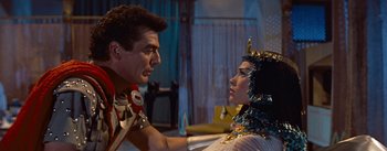 Movie still from “The Egyptian” (1954), directed by Michael Curtiz – A man and a woman in egyptian garb talking to each other; Medium shot, Over the shoulder angle