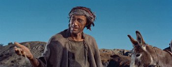 Movie still from “The Egyptian” (1954), directed by Michael Curtiz – A man with a beard and a head scarf on; Close Up shot, Low angle