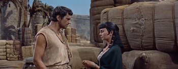 Movie still from “The Egyptian” (1954), directed by Michael Curtiz – A man and a woman are standing next to each other; Medium shot, Over the shoulder angle
