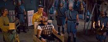 Movie still from “The Egyptian” (1954), directed by Michael Curtiz – A group of men standing next to each other; Medium shot, High angle