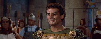 Movie still from “The Egyptian” (1954), directed by Michael Curtiz – A person wearing a costume; Close Up shot, Over the shoulder angle