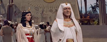 Movie still from “The Egyptian” (1954), directed by Michael Curtiz – A statue of an ancient egyptian king in a museum setting; Medium shot, Low angle
