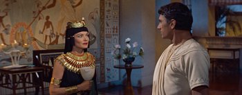 Movie still from “The Egyptian” (1954), directed by Michael Curtiz – A woman and a man dressed in ancient egyptian clothing; Medium shot, Over the shoulder angle