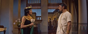 Movie still from “The Egyptian” (1954), directed by Michael Curtiz – A woman and a man dressed in ancient egyptian clothing; Medium shot, Over the shoulder angle
