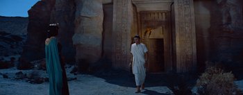 Movie still from “The Egyptian” (1954), directed by Michael Curtiz – A man standing in front of an egyptian building; Wide shot, Low angle