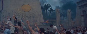 Movie still from “The Egyptian” (1954), directed by Michael Curtiz – A group of people standing in front of an egyptian mural; Extreme Wide shot, Low angle