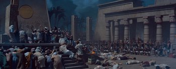 Movie still from “The Egyptian” (1954), directed by Michael Curtiz – A crowd of people sitting on steps in front of a building; Extreme Wide shot, High angle