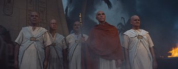 Movie still from “The Egyptian” (1954), directed by Michael Curtiz – A group of men standing next to each other; Medium shot, Low angle