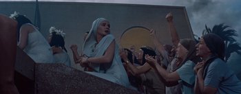 Movie still from “The Egyptian” (1954), directed by Michael Curtiz – A crowd of people gathered around a woman in a toga; Medium shot, Low angle
