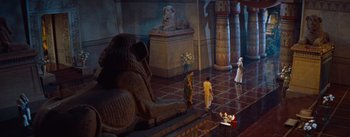 Movie still from “The Egyptian” (1954), directed by Michael Curtiz – A group of people standing in a room with statues; Extreme Wide shot, High angle