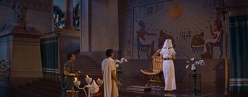 Movie still from “The Egyptian” (1954), directed by Michael Curtiz – A man in a toga standing in front of a wall; Extreme Wide shot, Low angle