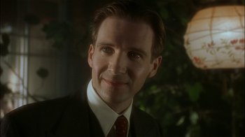 Movie still from “The End of the Affair” (1999), directed by Neil Jordan – A person wearing a suit and tie; Close Up shot, Low angle