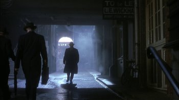 Movie still from “The End of the Affair” (1999), directed by Neil Jordan – A person walking in the dark in a tunnel; Wide shot, Low angle