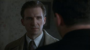 Movie still from “The End of the Affair” (1999), directed by Neil Jordan – A person in a suit looking at a mirror; Close Up shot, Over the shoulder angle