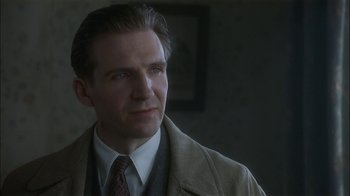 Movie still from “The End of the Affair” (1999), directed by Neil Jordan – A person wearing a suit and tie; Close Up shot, Low angle