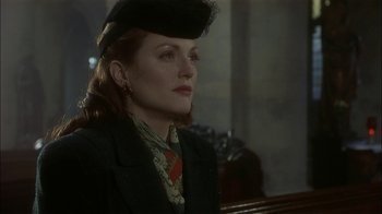 Movie still from “The End of the Affair” (1999), directed by Neil Jordan – A woman wearing a black hat and a black jacket; Close Up shot, Over the shoulder angle