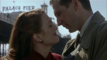 Movie still from “The End of the Affair” (1999), directed by Neil Jordan – A man and a woman face to face in front of a pier; Close Up shot, Low angle