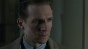 Movie still from “The End of the Affair” (1999), directed by Neil Jordan – A person wearing a suit and tie; Close Up shot, Low angle