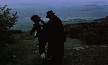 Movie still from “The Enigma of Kaspar Hauser” (1974), directed by Werner Herzog – A man and a woman standing on top of a hill; Wide shot, High angle