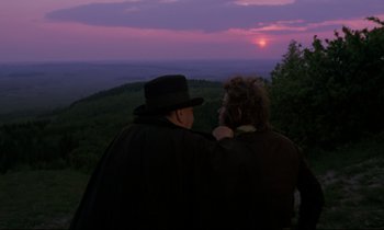 Movie still from “The Enigma of Kaspar Hauser” (1974), directed by Werner Herzog – Two men standing on top of a hill looking at the sunset; Medium shot, Over the shoulder angle
