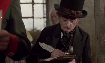 Movie still from “The Enigma of Kaspar Hauser” (1974), directed by Werner Herzog – A man in a top hat writing on a piece of paper; Close Up shot, Over the shoulder angle