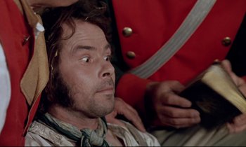 Movie still from “The Enigma of Kaspar Hauser” (1974), directed by Werner Herzog – A person wearing a red jacket; Close Up shot, Over the shoulder angle