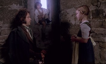 Movie still from “The Enigma of Kaspar Hauser” (1974), directed by Werner Herzog – A man and a woman in a room with a child; Medium shot, Over the shoulder angle