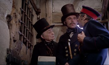 Movie still from “The Enigma of Kaspar Hauser” (1974), directed by Werner Herzog – A group of men in top hats standing next to each other; Medium shot, Over the shoulder angle