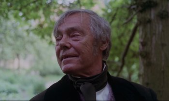 Movie still from “The Enigma of Kaspar Hauser” (1974), directed by Werner Herzog – An older man wearing a neck tie and a black jacket; Close Up shot, Low angle