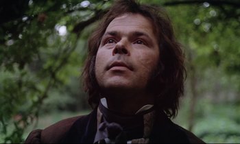 Movie still from “The Enigma of Kaspar Hauser” (1974), directed by Werner Herzog – A person with long hair wearing a suit; Close Up shot, Low angle