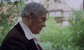 Movie still from “The Enigma of Kaspar Hauser” (1974), directed by Werner Herzog – An older man in a suit and tie looking off into the distance; Close Up shot, Over the shoulder angle