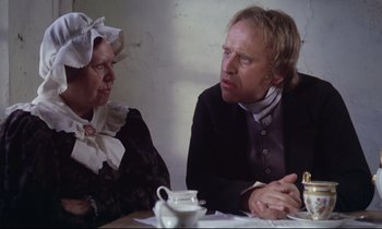 Movie still from “The Enigma of Kaspar Hauser” (1974), directed by Werner Herzog – A man and a woman sitting at a dinner table; Medium shot, Over the shoulder angle