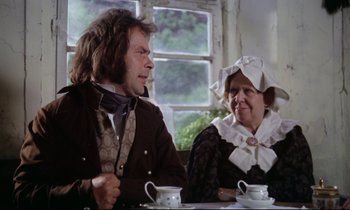 Movie still from “The Enigma of Kaspar Hauser” (1974), directed by Werner Herzog – A man and a woman sitting at a table with cups; Medium shot, Over the shoulder angle
