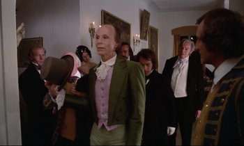 Movie still from “The Enigma of Kaspar Hauser” (1974), directed by Werner Herzog – A group of people dressed up in costumes; Medium shot, Over the shoulder angle