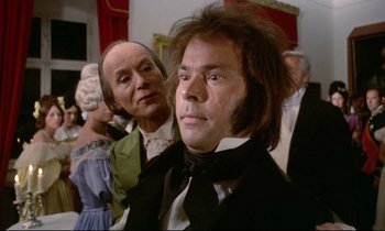 Movie still from “The Enigma of Kaspar Hauser” (1974), directed by Werner Herzog – A man in a black suit and a woman in a white dress; Close Up shot, Over the shoulder angle