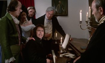 Movie still from “The Enigma of Kaspar Hauser” (1974), directed by Werner Herzog – A group of people sitting around a table; Medium shot, High angle