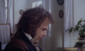Movie still from “The Enigma of Kaspar Hauser” (1974), directed by Werner Herzog – A person wearing a suit and tie; Close Up shot, Over the shoulder angle