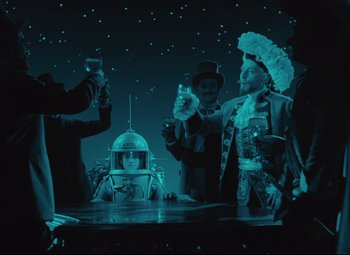 Movie still from “The Fabulous Baron Munchausen” (1962), directed by Karel Zeman – A group of people standing around a table; Wide shot, Low angle