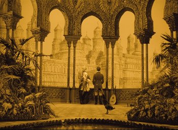 Movie still from “The Fabulous Baron Munchausen” (1962), directed by Karel Zeman – Two people are standing in front of an ornate building; Extreme Wide shot, High angle