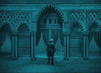 Movie still from “The Fabulous Baron Munchausen” (1962), directed by Karel Zeman – A person standing in front of an ornate archway; Extreme Wide shot, High angle