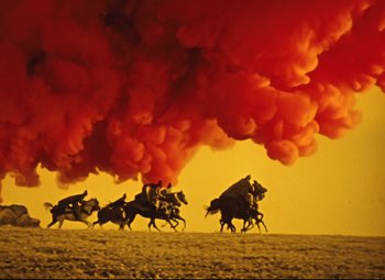 Movie still from “The Fabulous Baron Munchausen” (1962), directed by Karel Zeman – A group of people riding horses under a red cloud formation; Extreme Wide shot, Low angle