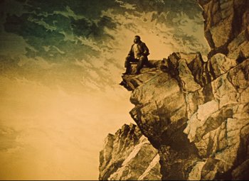 Movie still from “The Fabulous Baron Munchausen” (1962), directed by Karel Zeman – A man sitting on top of a rock on top of a mountain; Wide shot, Low angle