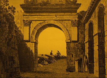 Movie still from “The Fabulous Baron Munchausen” (1962), directed by Karel Zeman – An old photo of two men sitting under an archway; Extreme Wide shot, Low angle