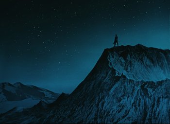 Movie still from “The Fabulous Baron Munchausen” (1962), directed by Karel Zeman – A man standing on top of a mountain at night; Extreme Wide shot, Low angle