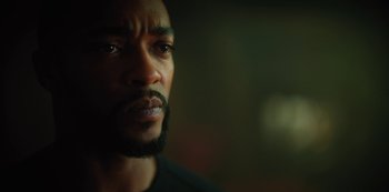 Movie still from “Altered Carbon” (2018), created by Laeta Kalogridis – A person with a beard looking at the camera; Close Up shot, Over the shoulder angle